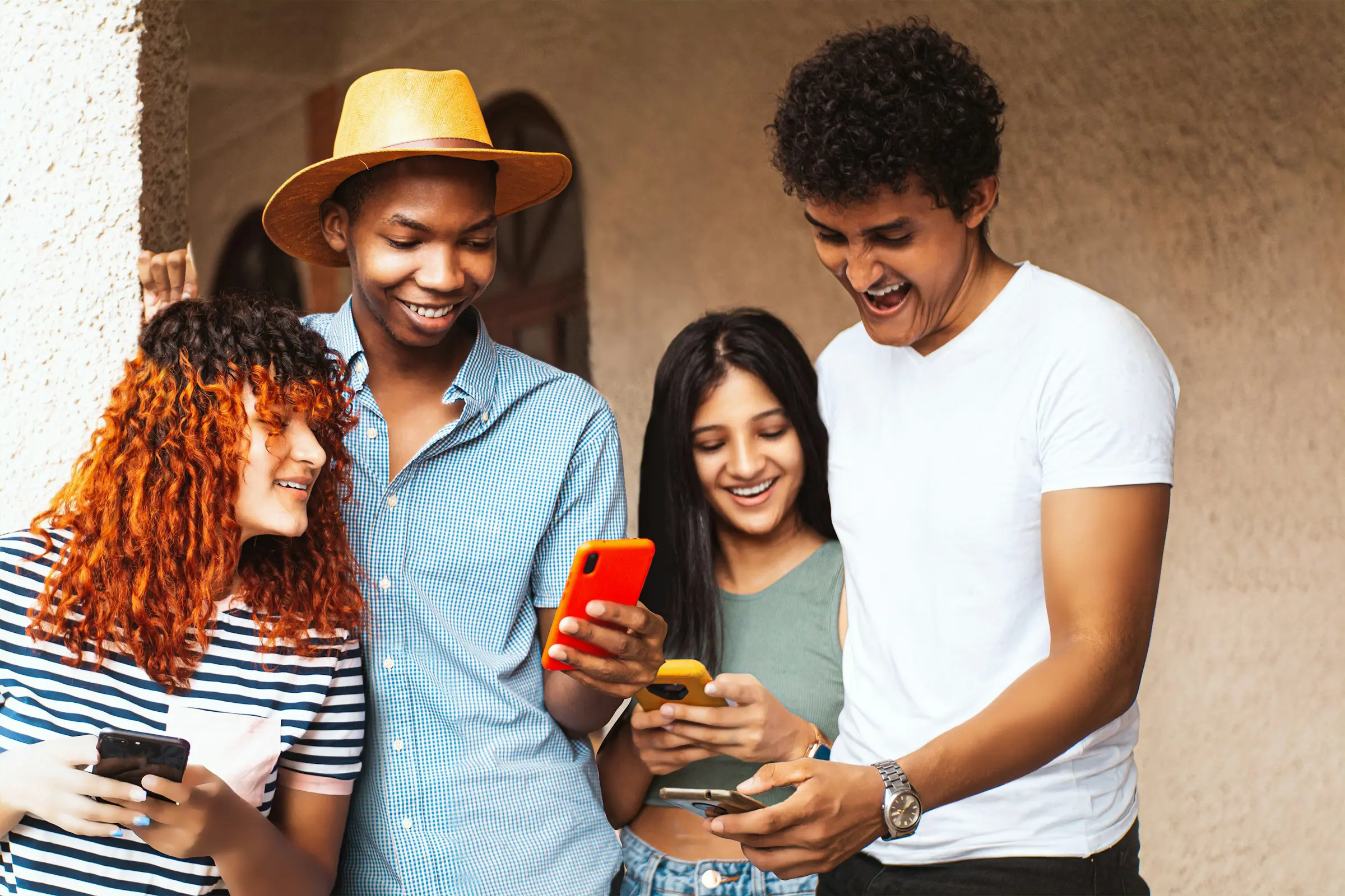 group of friends stand with each other and look at their phones when they use the FOREX currency app