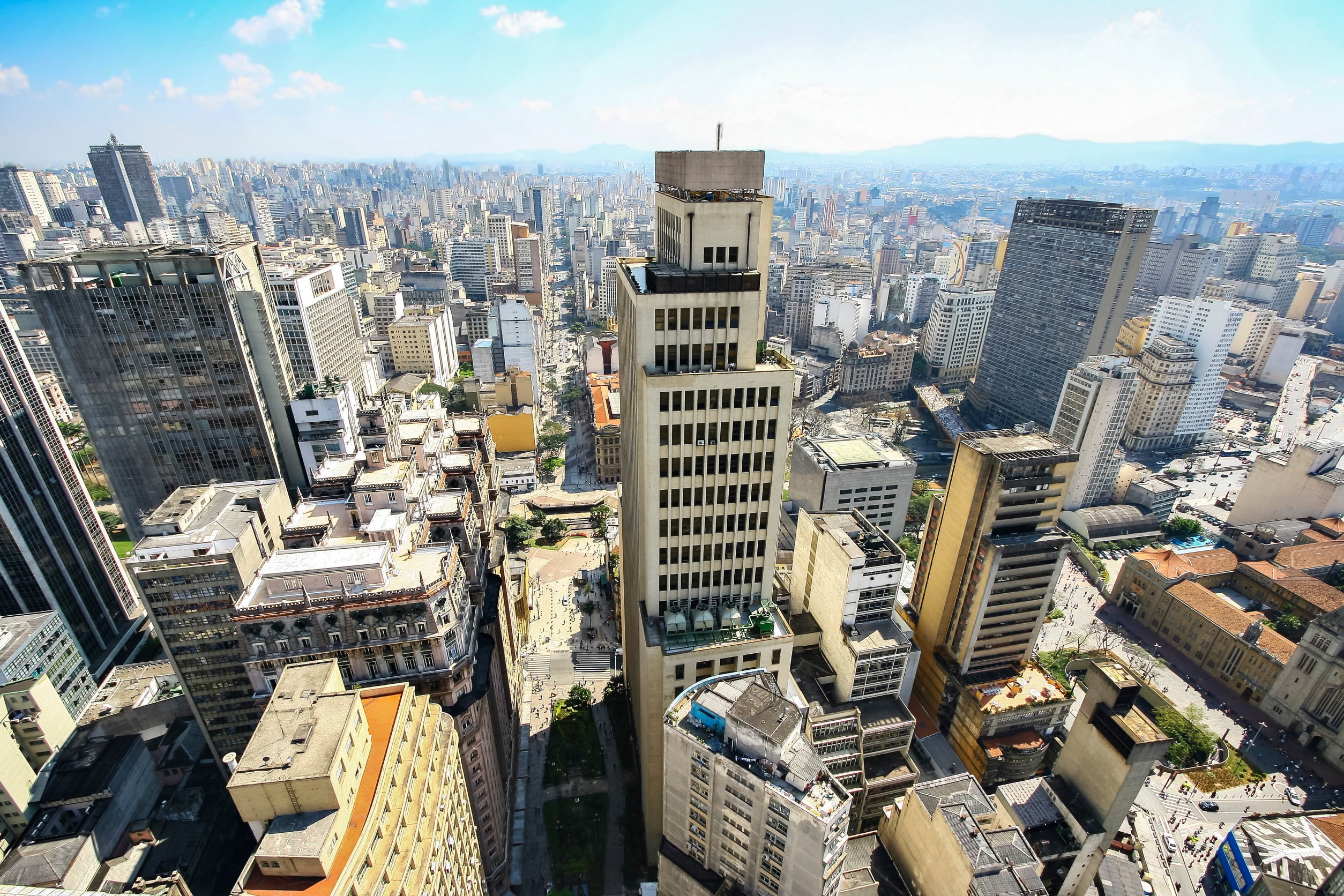 Overview of skyscrapers in São Paulo's financial district with roofs and traffic all around
